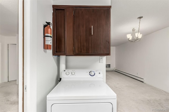 washroom featuring an inviting chandelier, cabinets, washer / dryer, a baseboard radiator, and light colored carpet