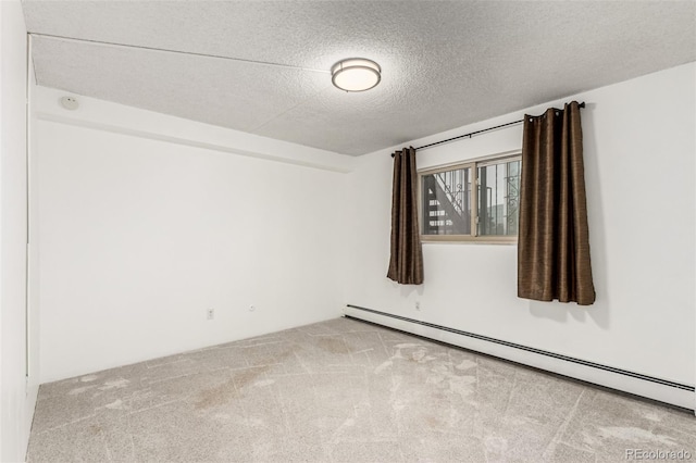 unfurnished room featuring light carpet, a textured ceiling, and a baseboard heating unit