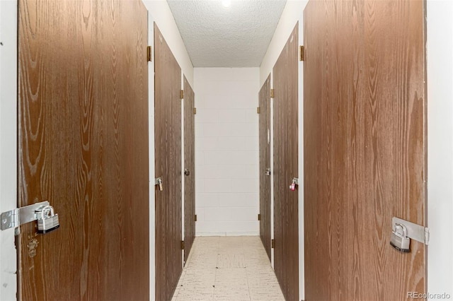 corridor featuring a textured ceiling