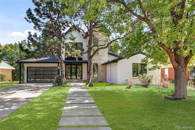 view of front of house featuring a garage and a front lawn