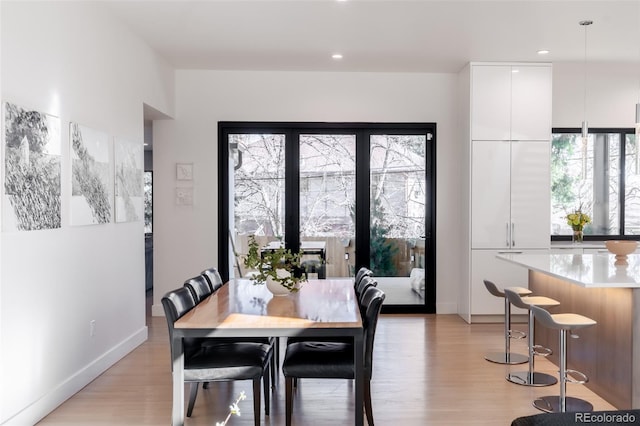 dining space with light wood-type flooring