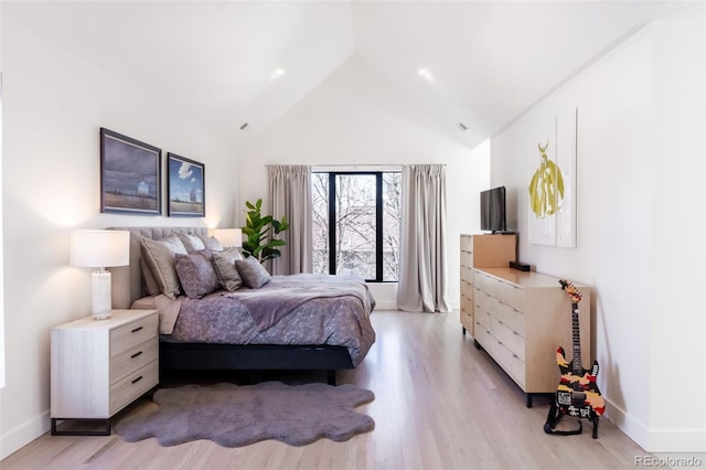 bedroom featuring lofted ceiling and light wood-type flooring