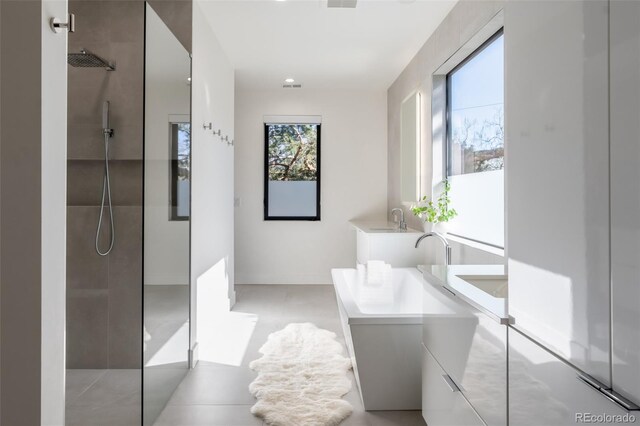 bathroom with vanity and tiled shower