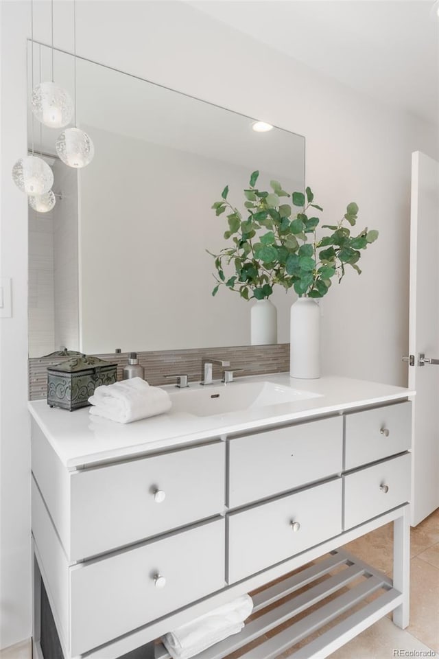 bathroom featuring vanity, backsplash, and tile patterned floors