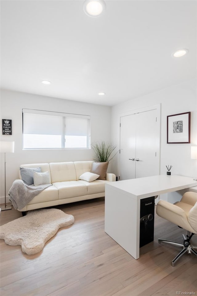 home office with light hardwood / wood-style flooring