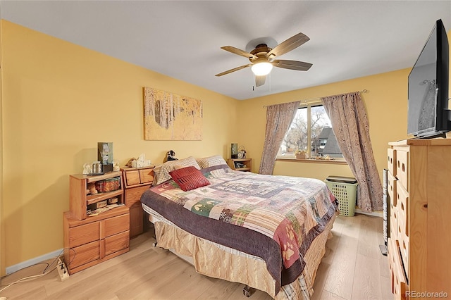 bedroom featuring ceiling fan and light hardwood / wood-style flooring