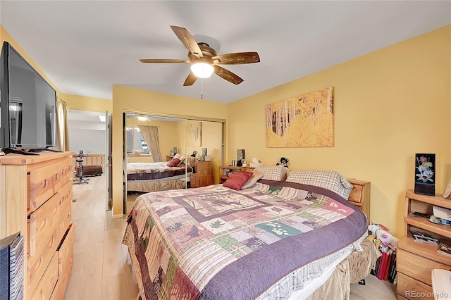 bedroom with ceiling fan, light hardwood / wood-style flooring, and a closet