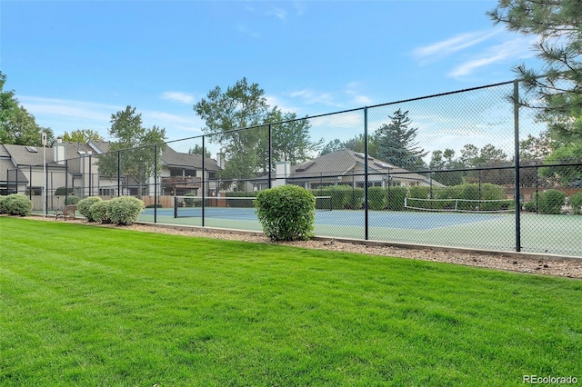 view of sport court with a yard