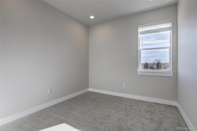 carpeted empty room with recessed lighting and baseboards