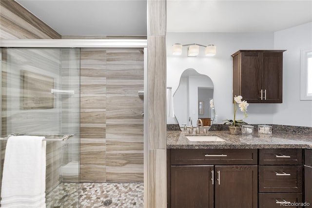 full bathroom with a stall shower and vanity