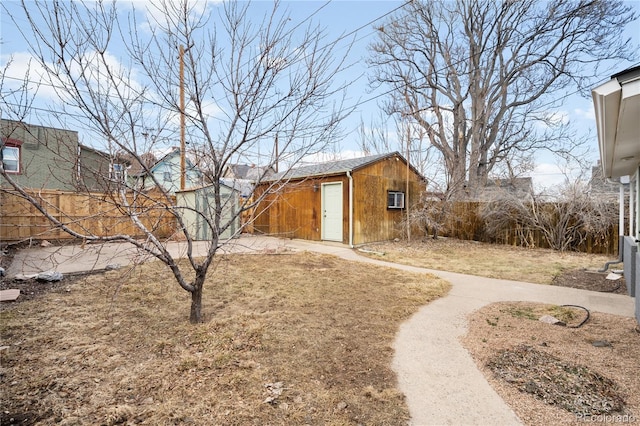 view of yard featuring an outdoor structure and fence