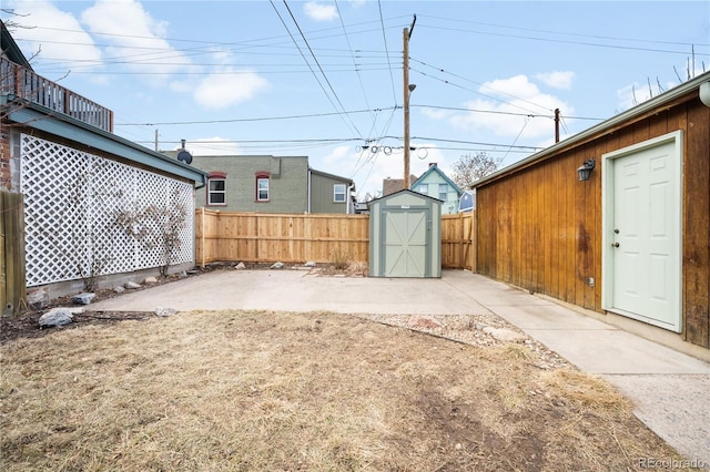 view of yard featuring fence, a storage unit, a patio, and an outdoor structure