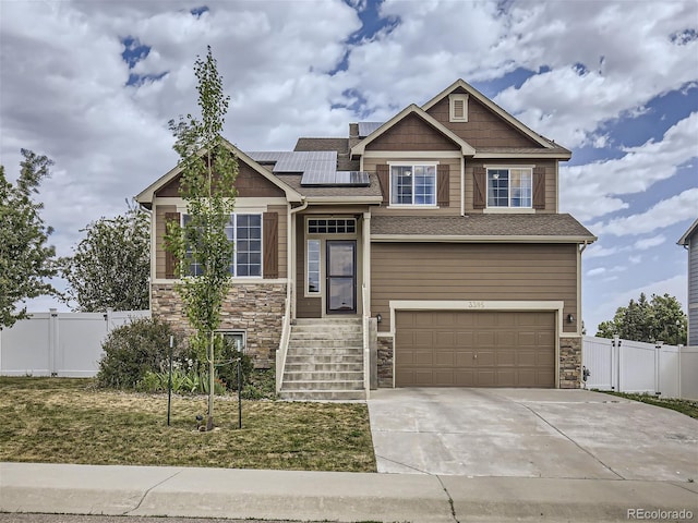 craftsman house featuring a garage and solar panels