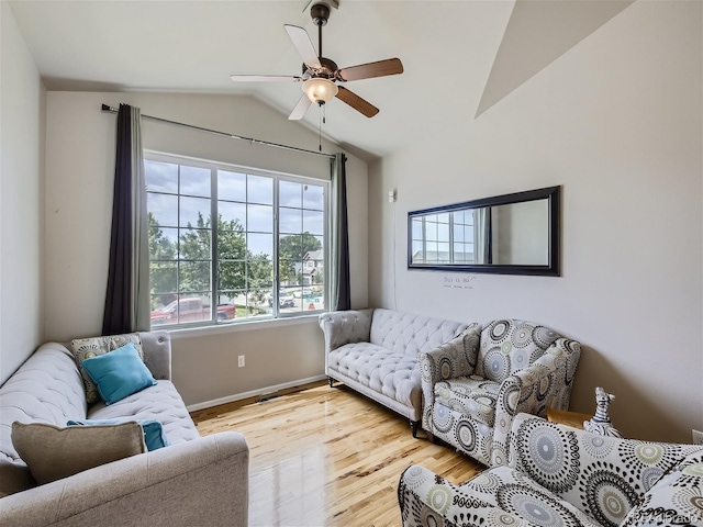 living room with ceiling fan, lofted ceiling, and light hardwood / wood-style floors