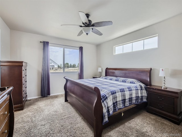 bedroom with multiple windows, ceiling fan, and carpet