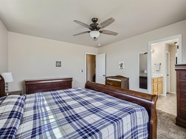 tiled bedroom with connected bathroom and ceiling fan