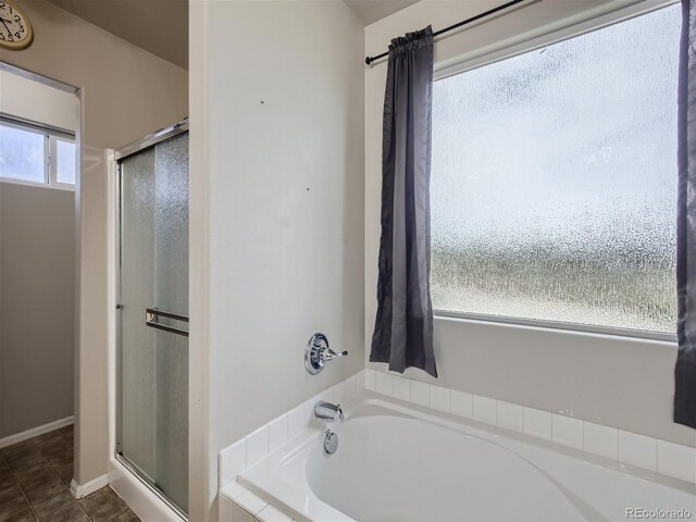 bathroom featuring tile flooring and shower with separate bathtub