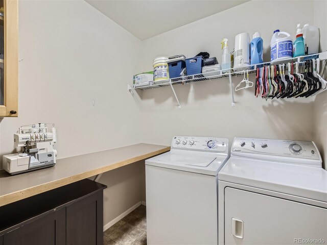 laundry area with washer and dryer and dark tile floors