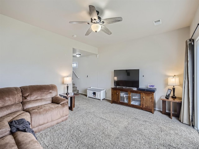 carpeted living room featuring ceiling fan