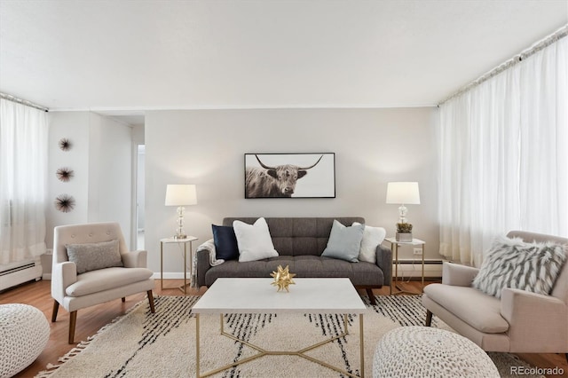 living area featuring a baseboard radiator, a baseboard heating unit, and wood finished floors