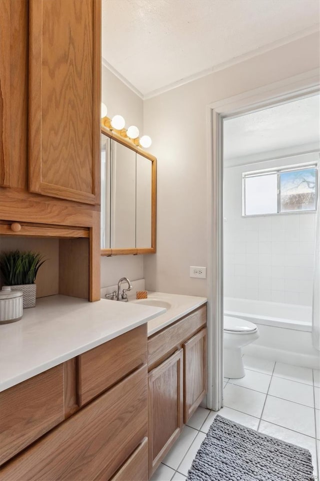 full bathroom featuring tile patterned flooring, vanity, tiled shower / bath combo, and toilet