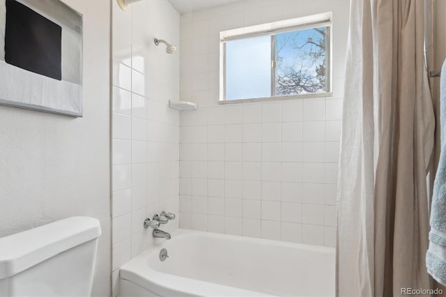 bathroom featuring toilet and shower / bath combo with shower curtain