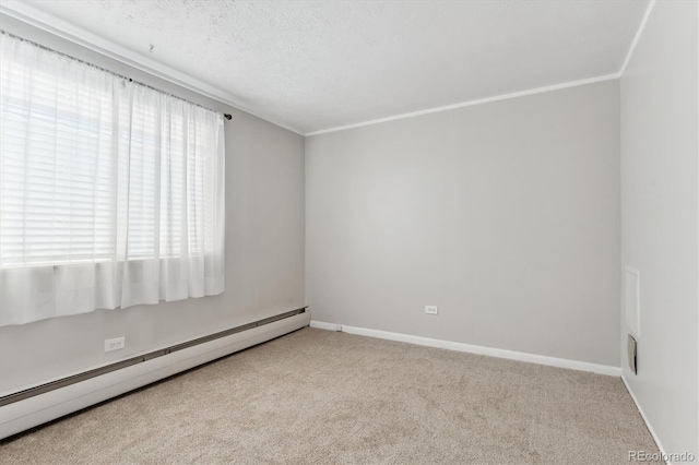 carpeted spare room featuring baseboards, baseboard heating, a textured ceiling, and ornamental molding