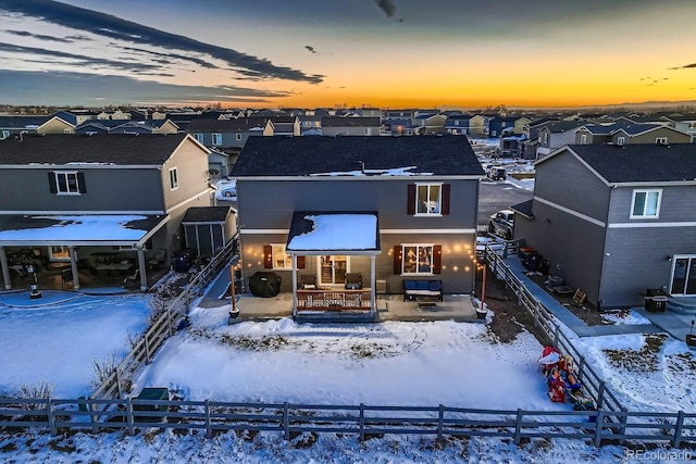 view of snow covered rear of property