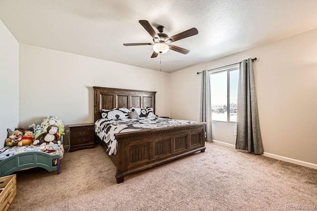 carpeted bedroom featuring ceiling fan and a textured ceiling