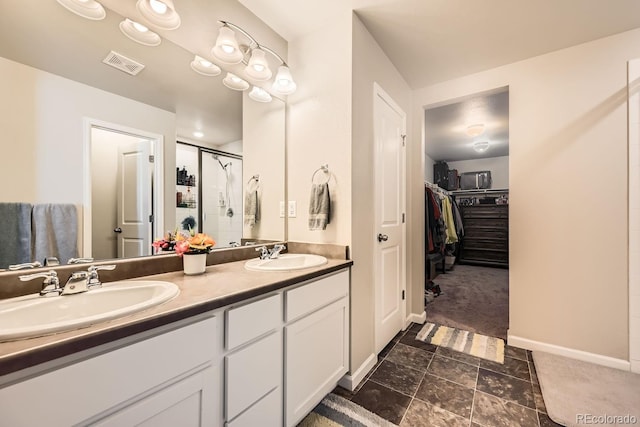 bathroom featuring vanity and tiled shower