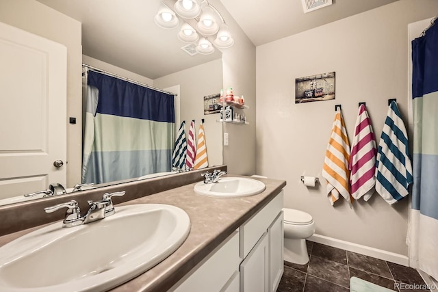 bathroom featuring vanity, tile patterned flooring, and toilet