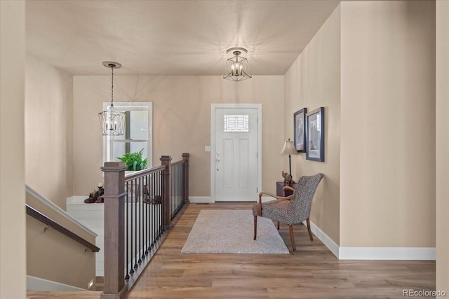 entrance foyer featuring a notable chandelier and light wood-type flooring