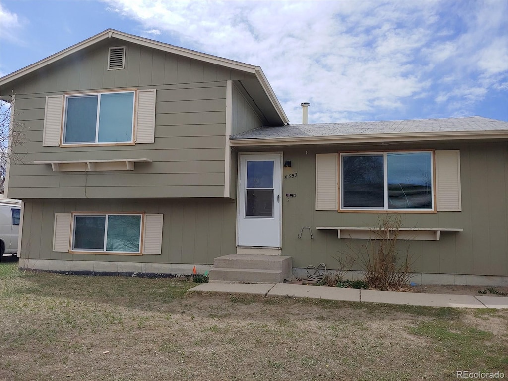 8353 Gaylord St, Denver, CO 80229 - tri-level home with entry steps, a front yard, and roof with shingles