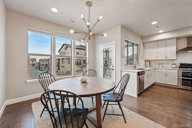dining room with visible vents, baseboards, a notable chandelier, and dark wood-style floors