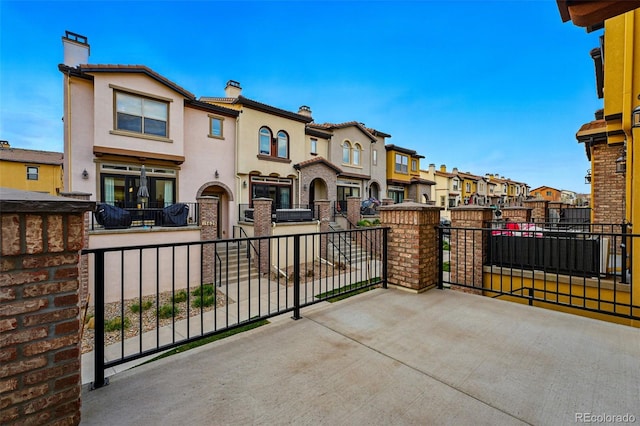 view of patio with a residential view and a balcony