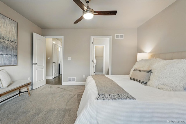bedroom with carpet flooring, visible vents, baseboards, and a ceiling fan