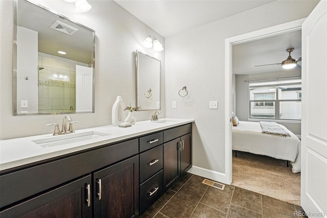 ensuite bathroom featuring visible vents, baseboards, and a sink