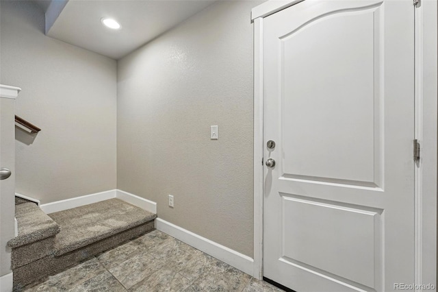 entryway featuring baseboards, stairs, and recessed lighting