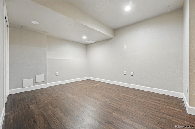 spare room featuring dark wood-style flooring, visible vents, baseboards, and recessed lighting