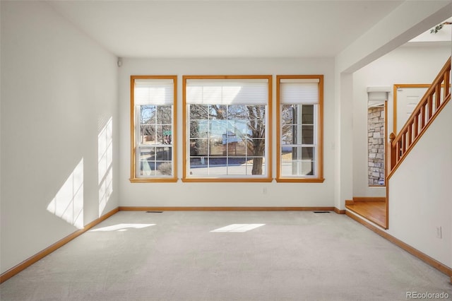 unfurnished room featuring light carpet