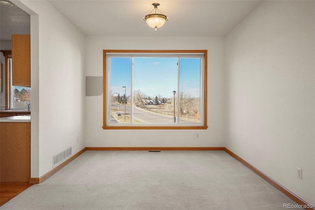 empty room with light colored carpet