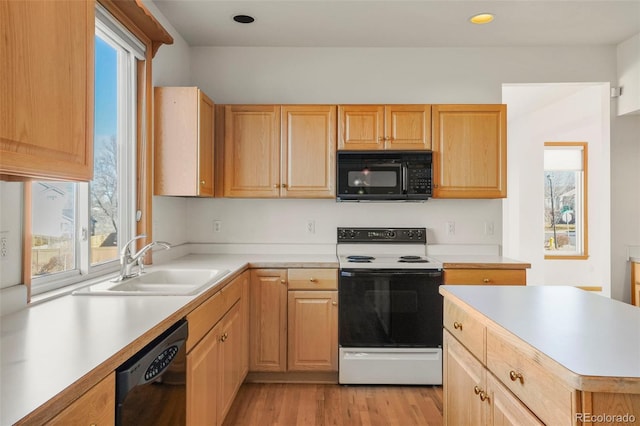 kitchen with sink, light hardwood / wood-style flooring, black appliances, and light brown cabinets