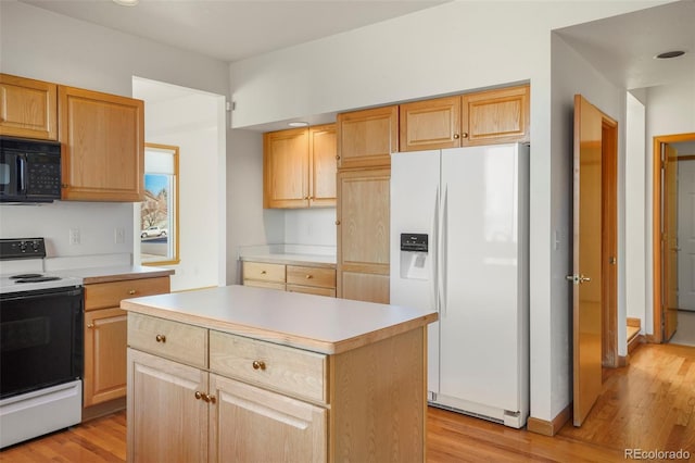 kitchen featuring light brown cabinetry, white appliances, light hardwood / wood-style flooring, and a center island