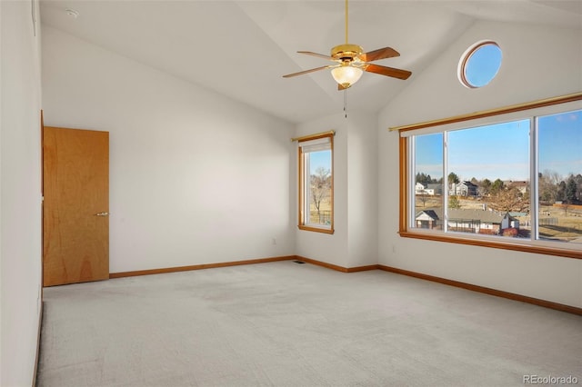 carpeted empty room featuring ceiling fan and high vaulted ceiling