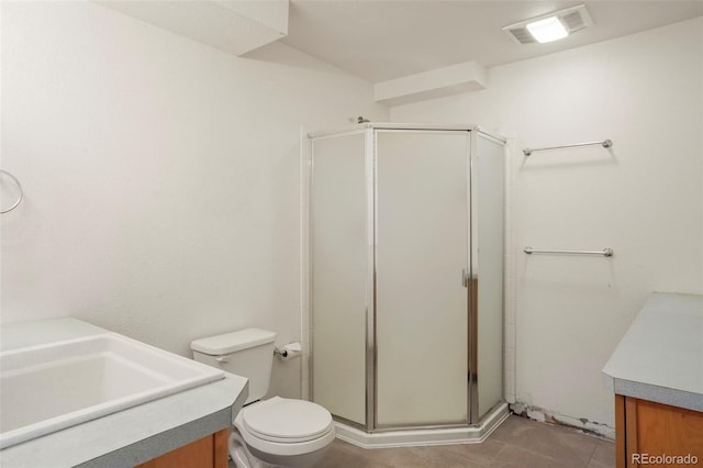 bathroom featuring vanity, an enclosed shower, and toilet