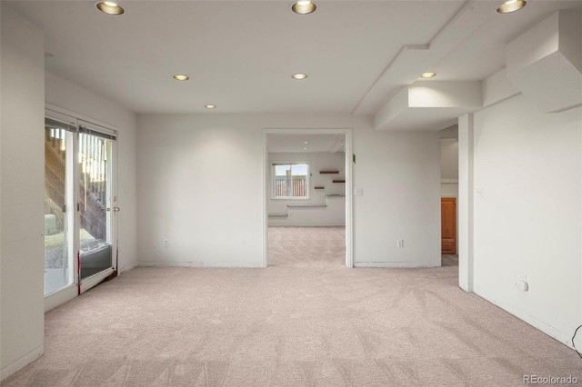 spare room featuring light colored carpet