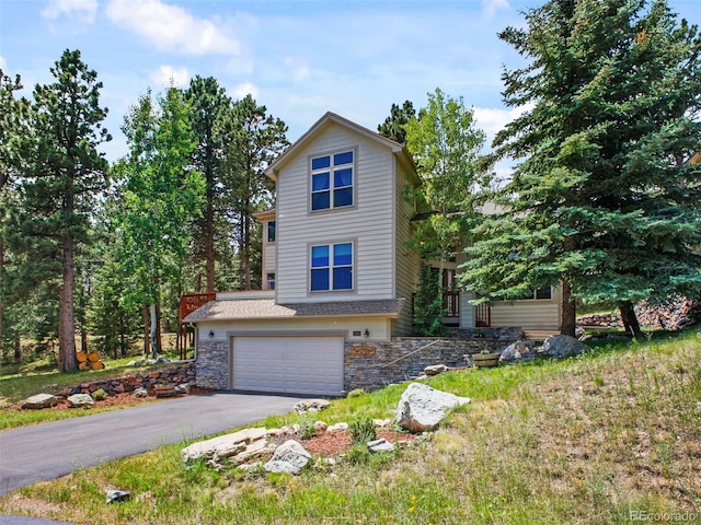 3648 Heatherwood Way, Evergreen, CO 80439 - view of front facade with a garage, driveway, and stone siding