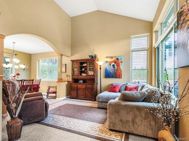3648 Heatherwood Way, Evergreen, CO 80439 - living area with arched walkways, high vaulted ceiling, a chandelier, and carpet