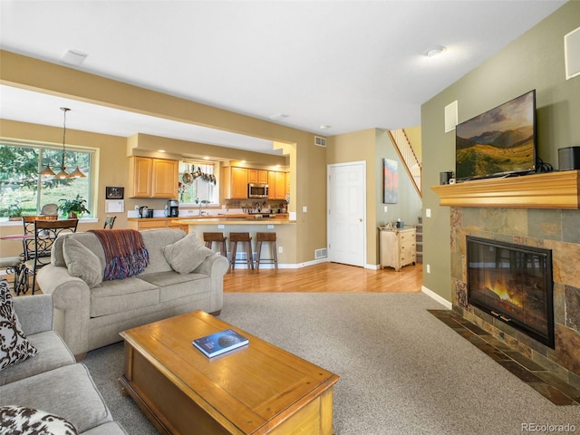 3648 Heatherwood Way, Evergreen, CO 80439 - living area featuring light colored carpet and a tiled fireplace
