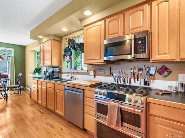 3648 Heatherwood Way, Evergreen, CO 80439 - kitchen featuring stainless steel appliances, light brown cabinets, healthy amount of natural light, light wood-style floors, and recessed lighting